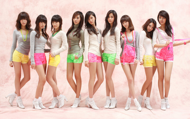 K-pop group in colorful outfits