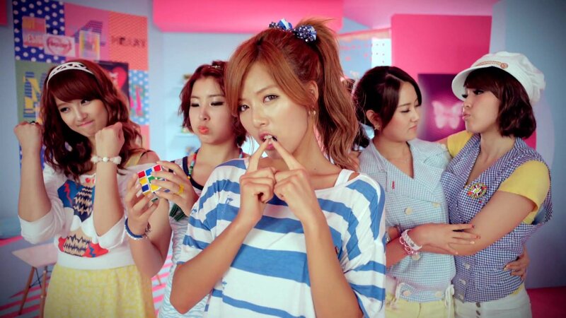K-pop group in colorful room