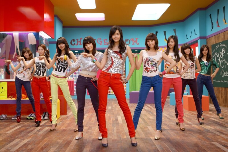 K-pop group in colorful room