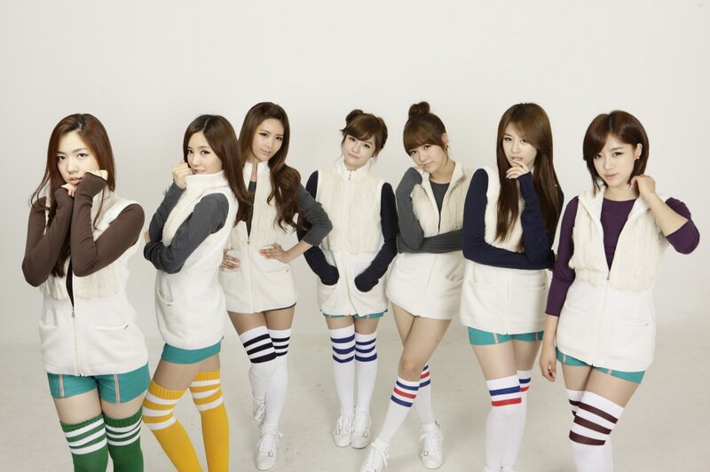 K-pop group in coordinated outfits