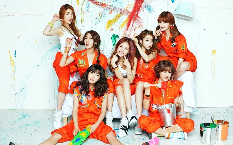 K-pop group in orange outfits