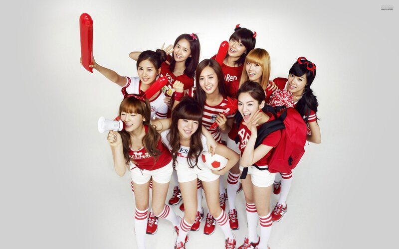 K-pop group in red and white outfits