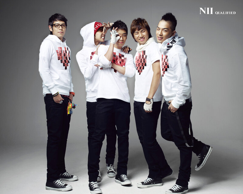 K-pop group in white hoodies
