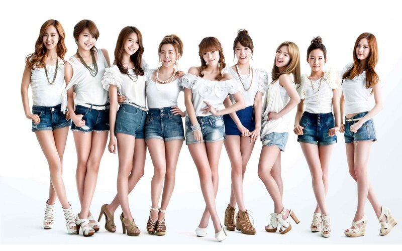 K-pop group in white tops and denim shorts