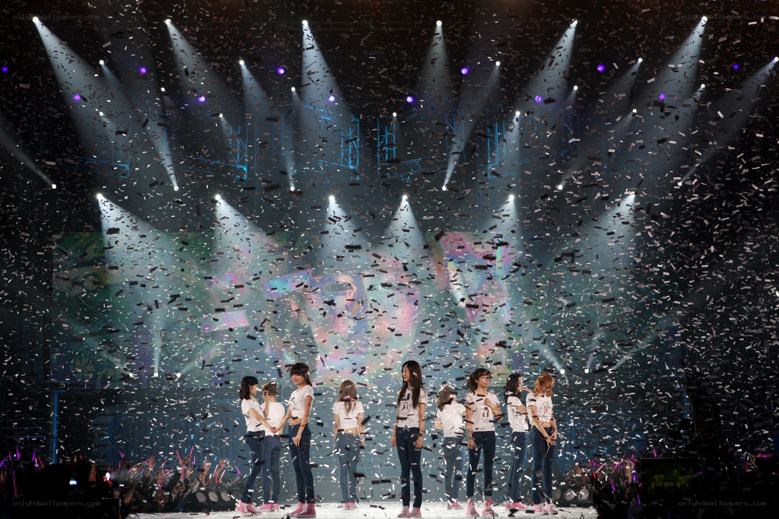 K-pop group on stage with confetti