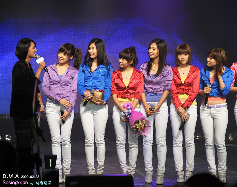 K-pop group on stage with host
