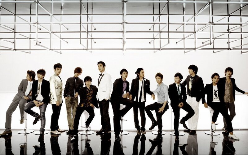 K-pop group on stools