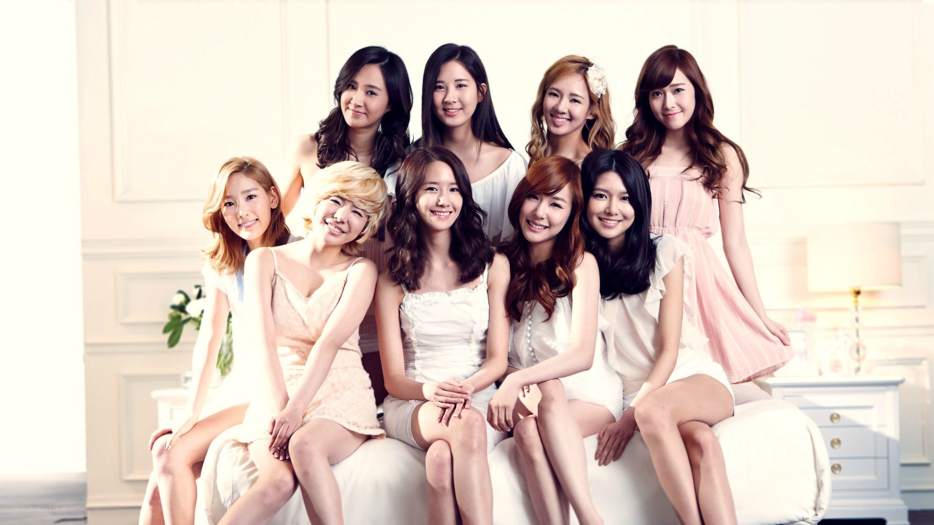 K-pop group photo on a sofa