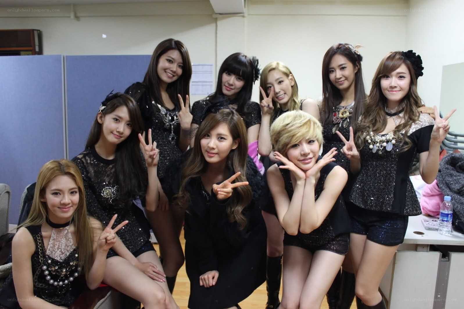 K-pop group posing backstage