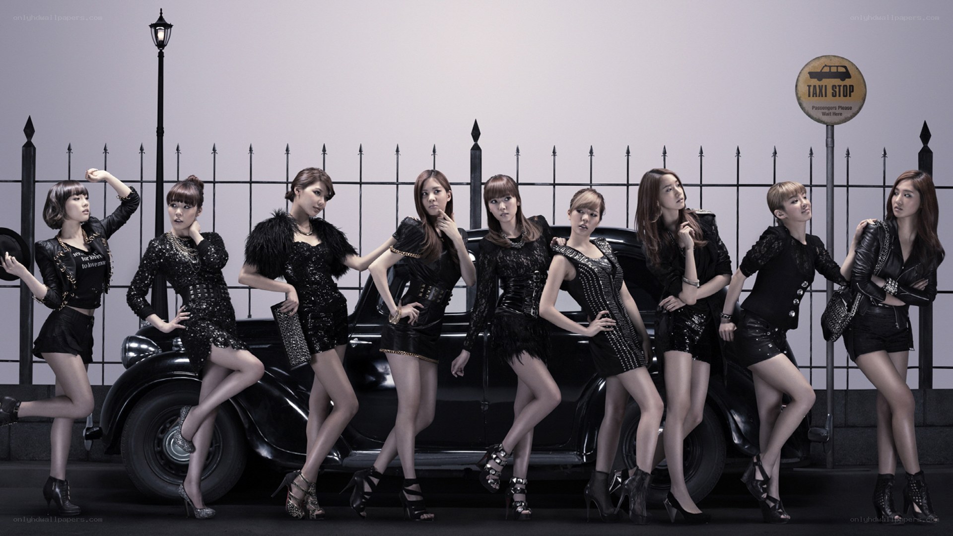 K-pop group posing by taxi stop