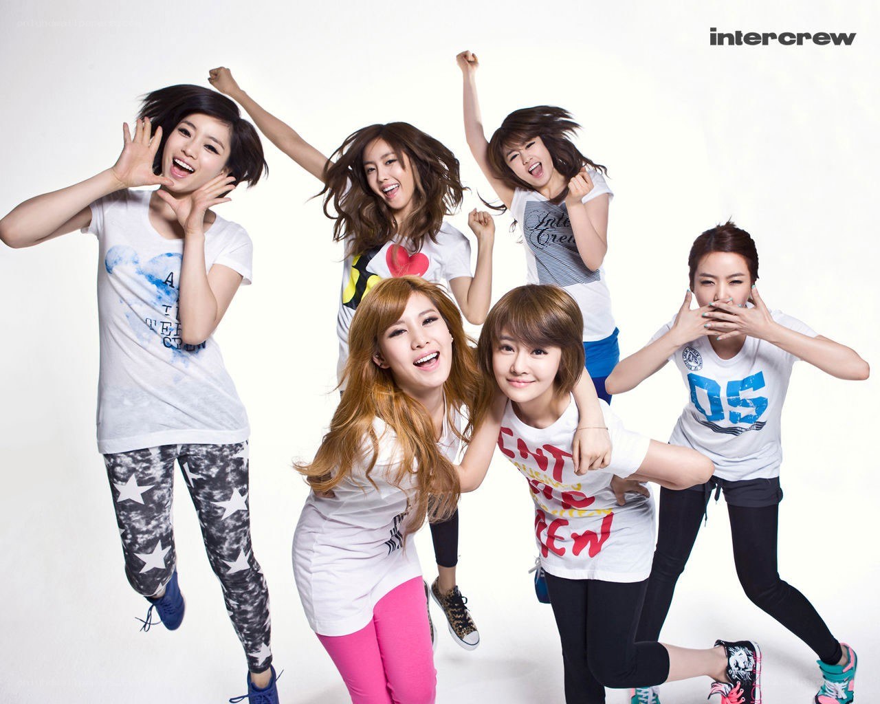 K-pop group posing energetically
