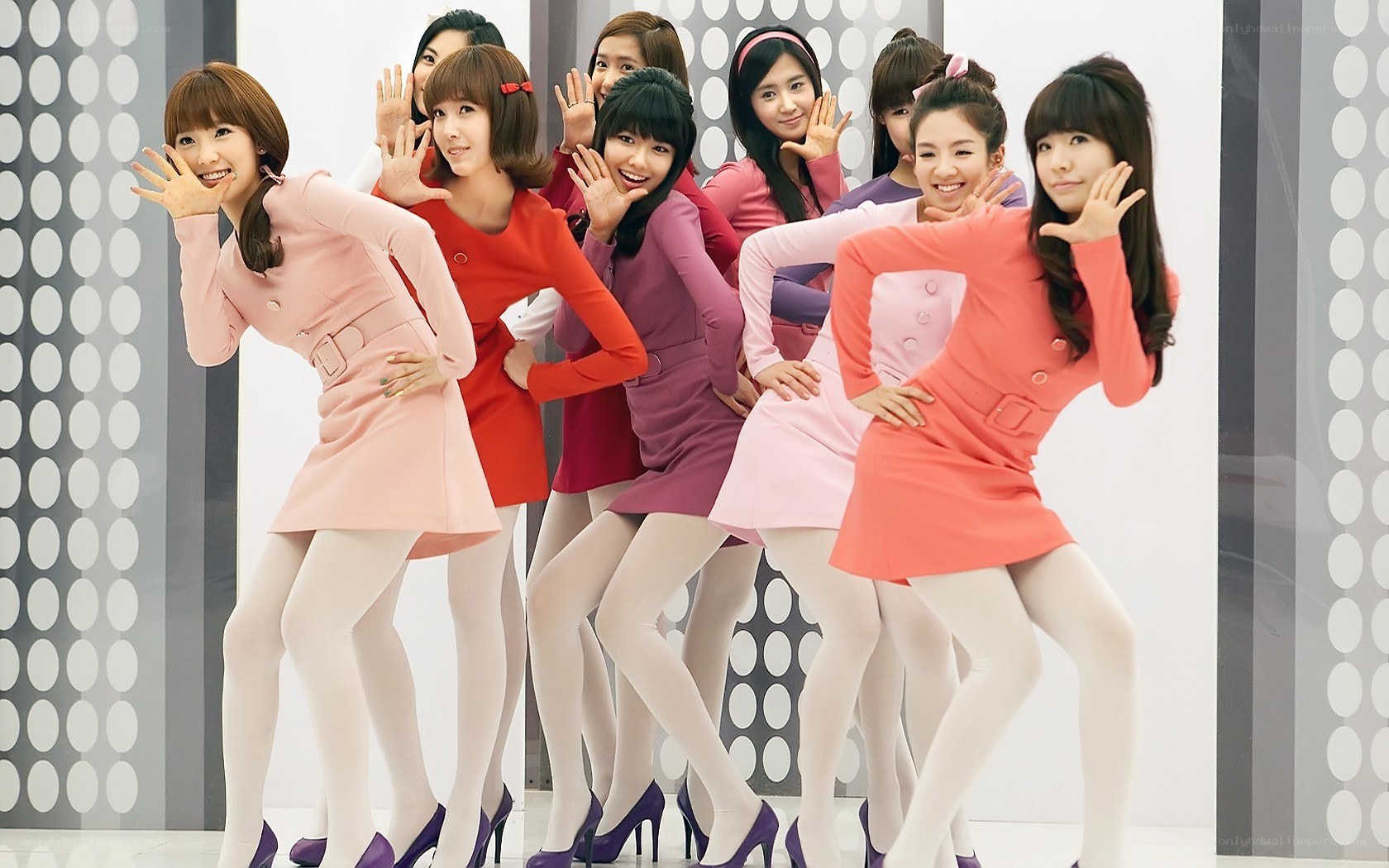 K-pop group posing in colorful dresses