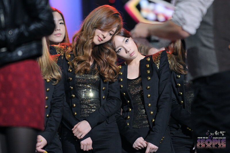 K-pop group posing on stage
