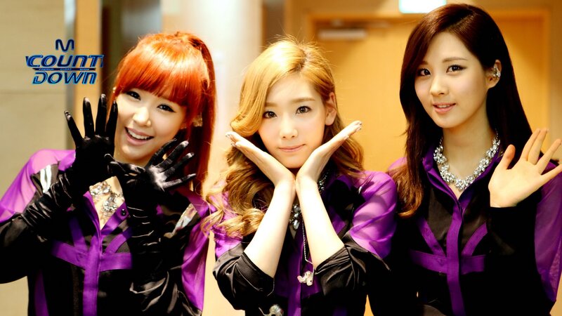 K-pop group posing on stage