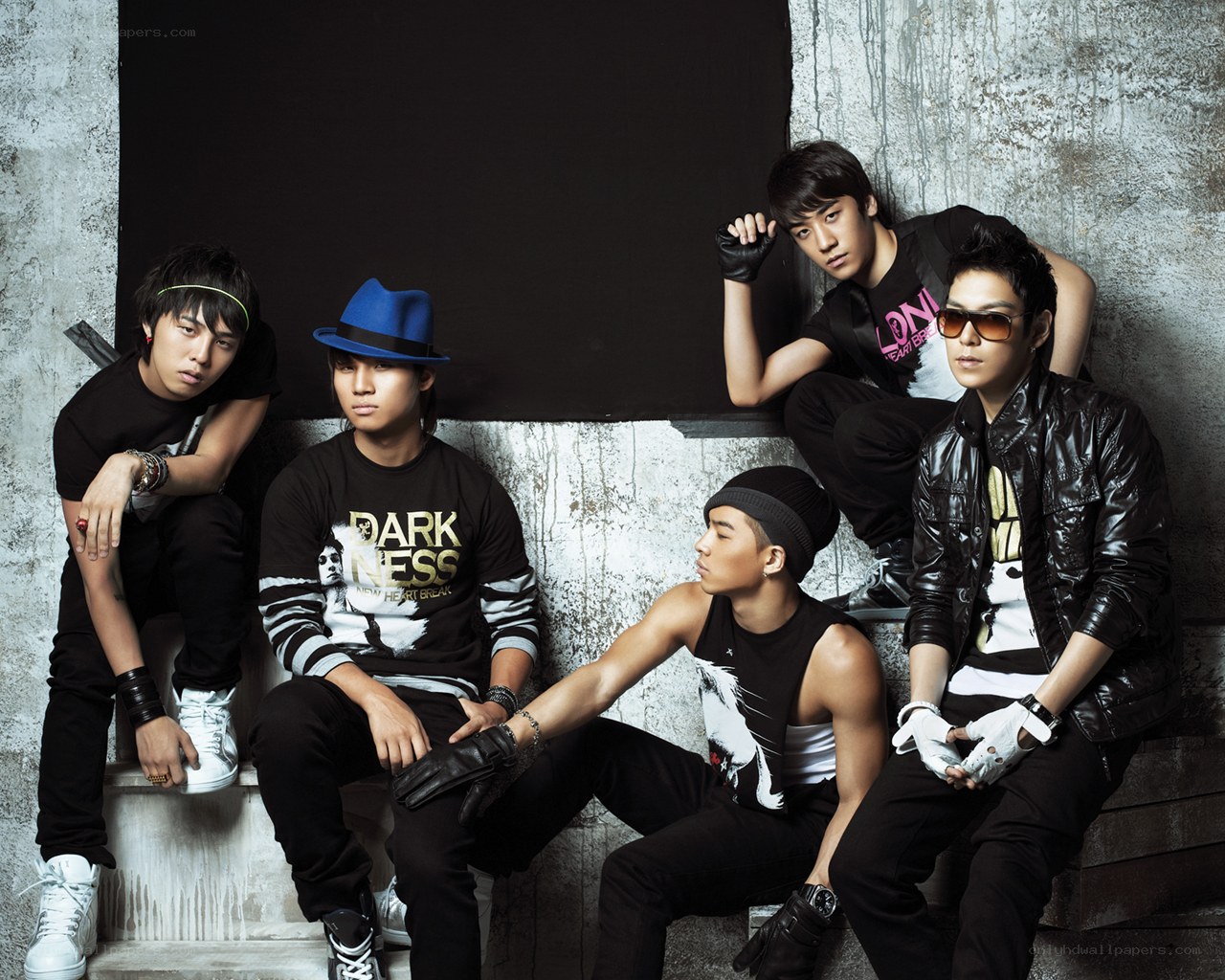 K-pop group posing on steps