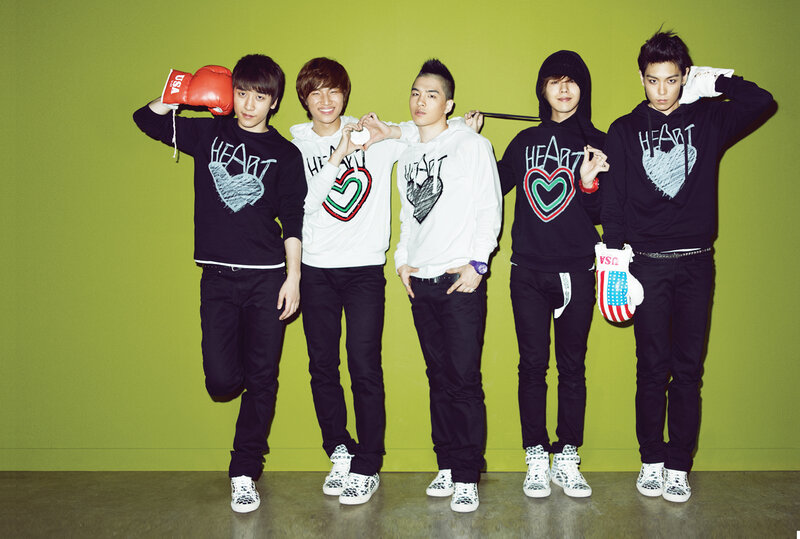 K-pop group posing with boxing gloves