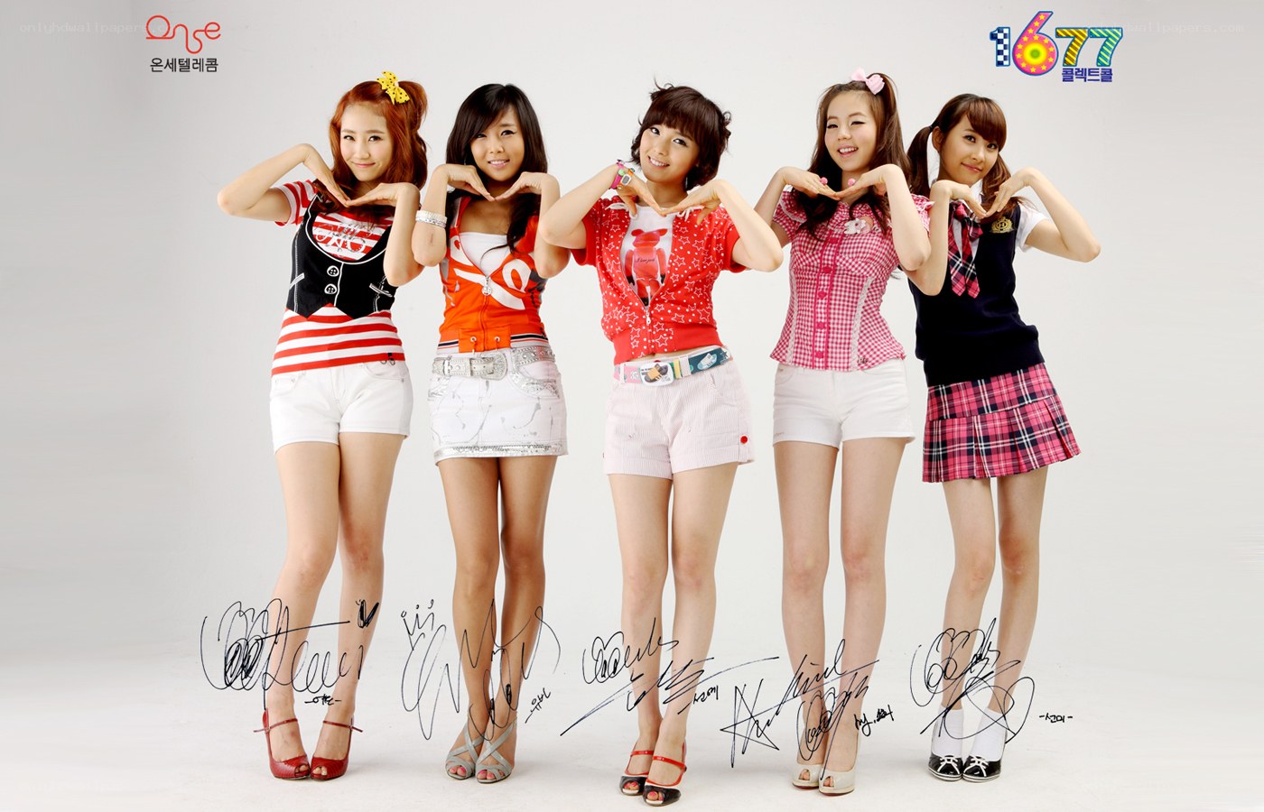 K-pop group posing with heart hands