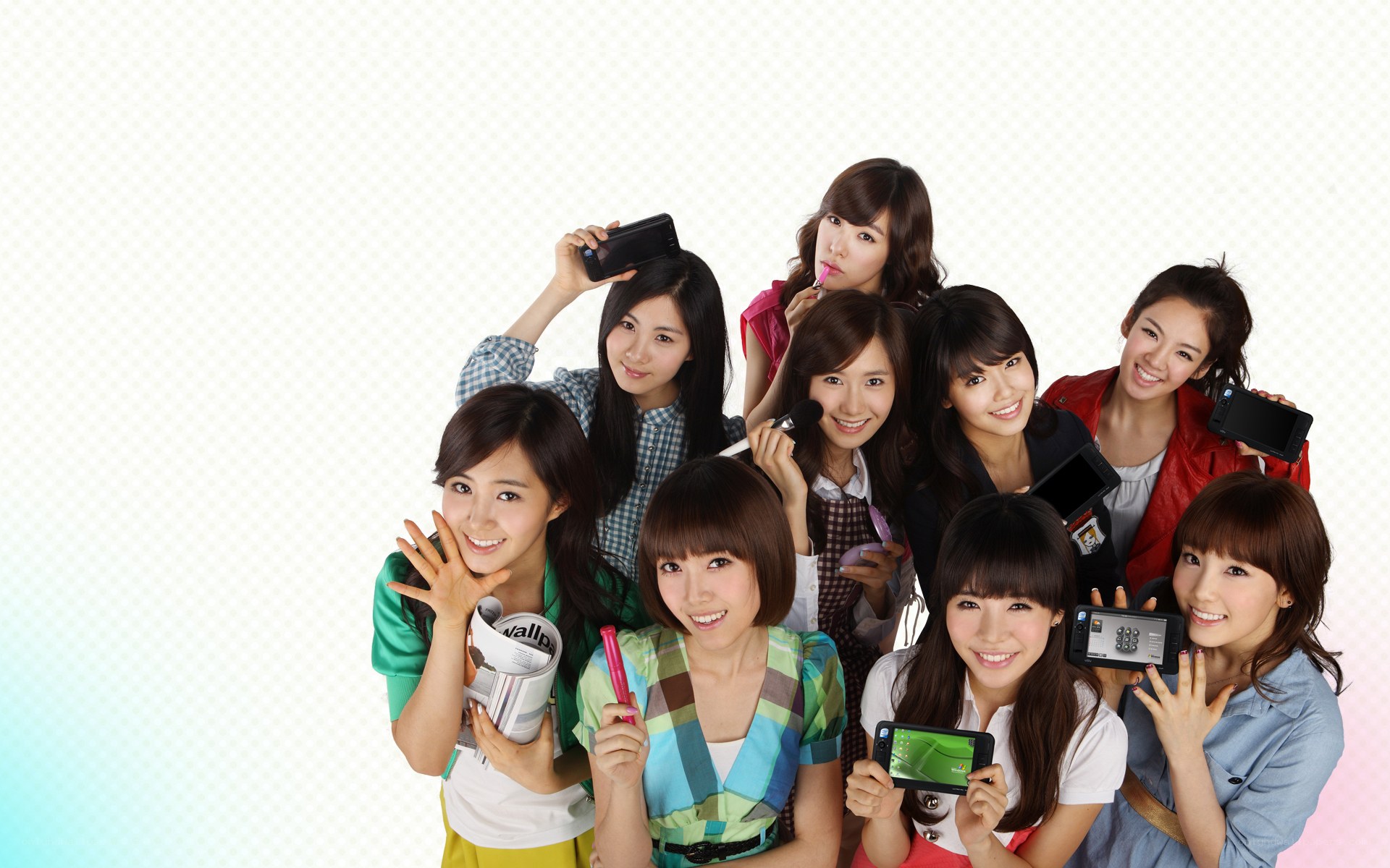 K-pop group posing with phones