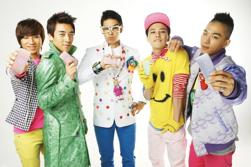 K-pop group posing with phones