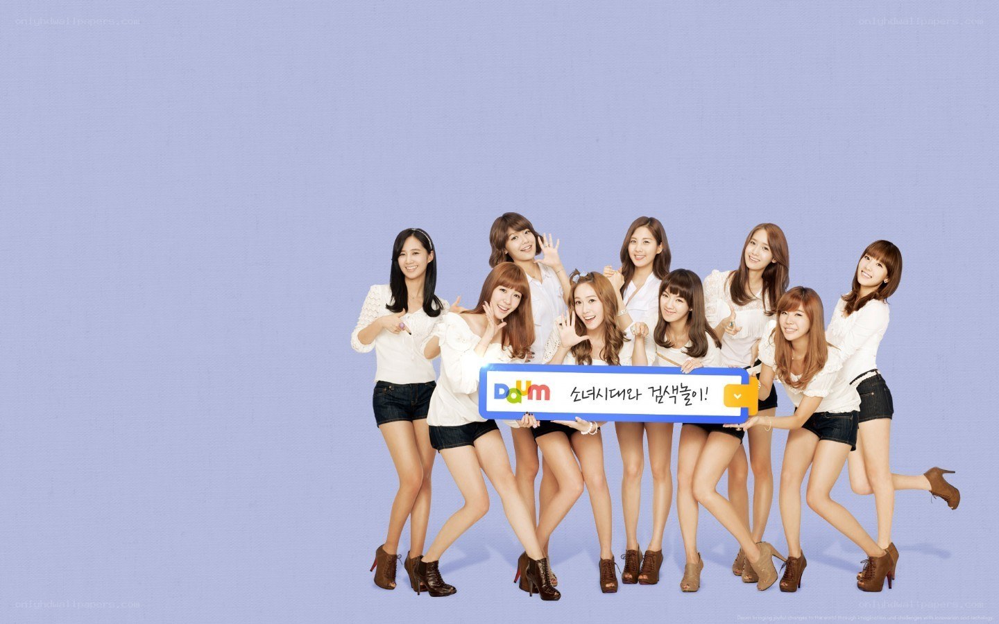 K-pop group posing with sign