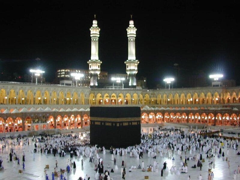 Kaaba at night with pilgrims