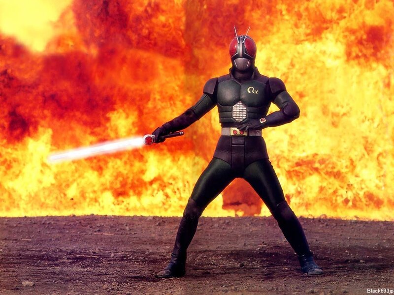 Kamen Rider Black stands in fire