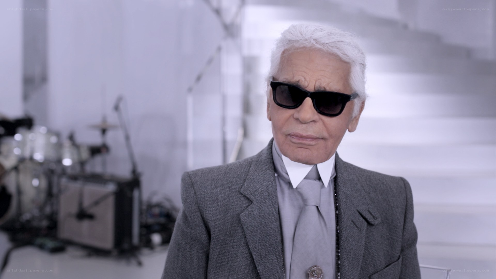Karl Lagerfeld in a gray suit