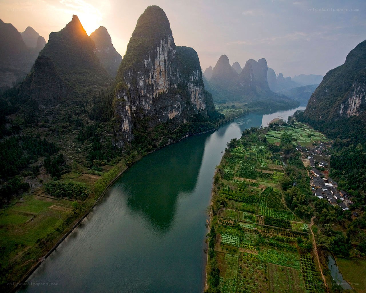 Karst mountains and river at sunset