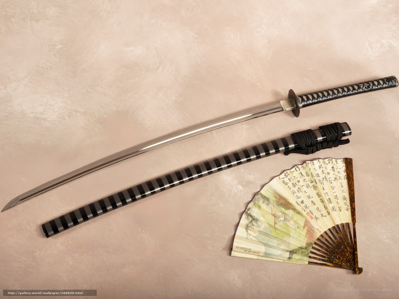 Katana and fan on textured surface