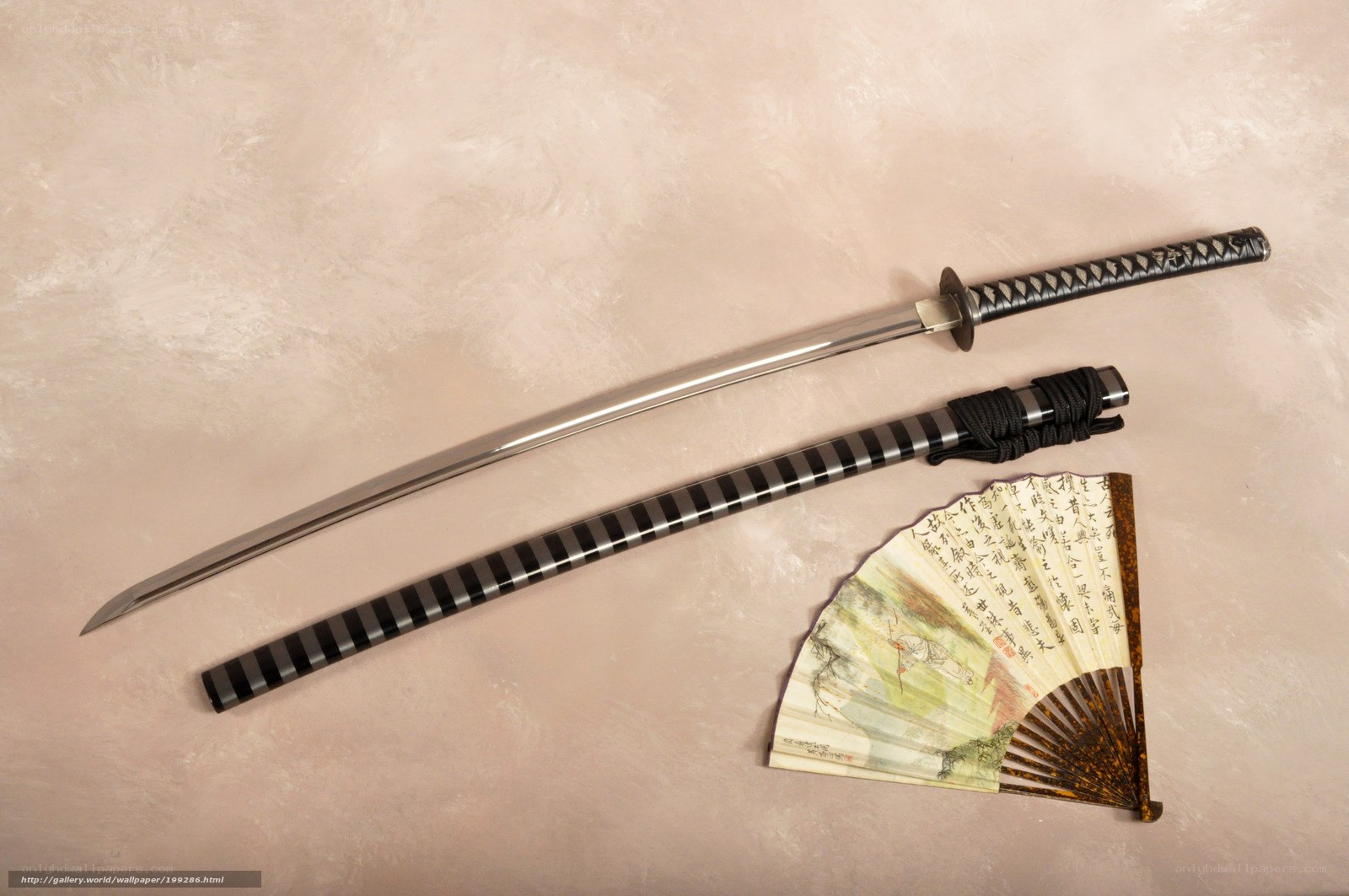 Katana and fan on textured surface
