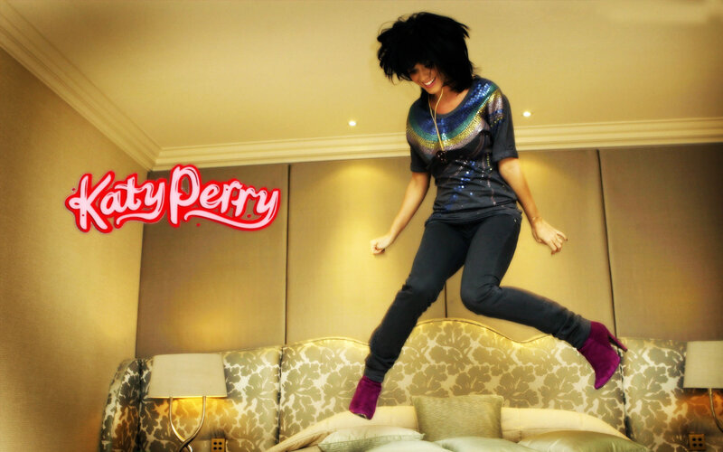 Katy Perry jumping on a bed