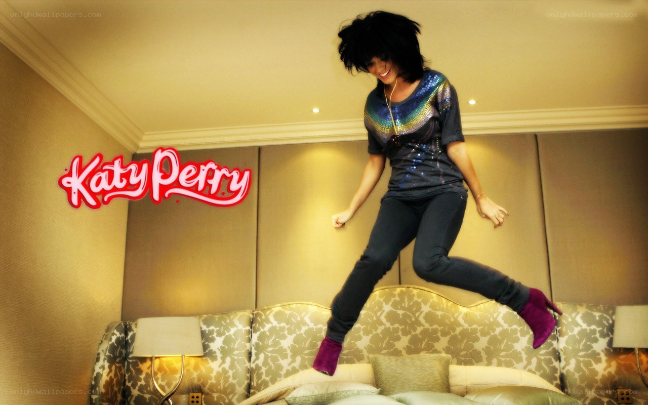 Katy Perry jumping on a bed