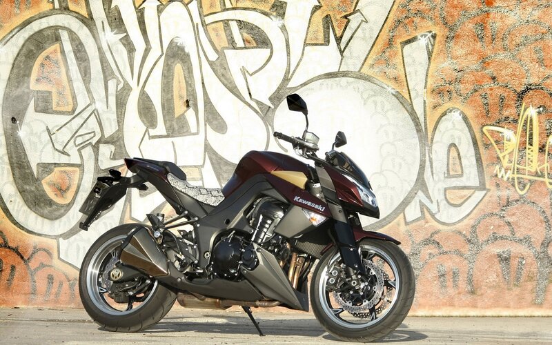 Kawasaki motorcycle in front of graffiti