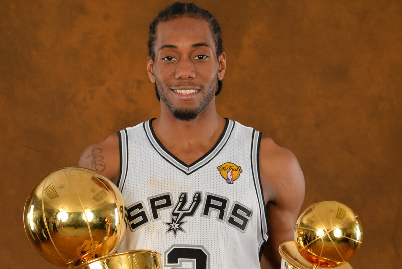 Kawhi Leonard with trophies