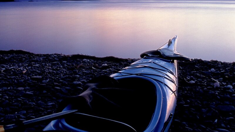 kayak on a pebble beach at dusk