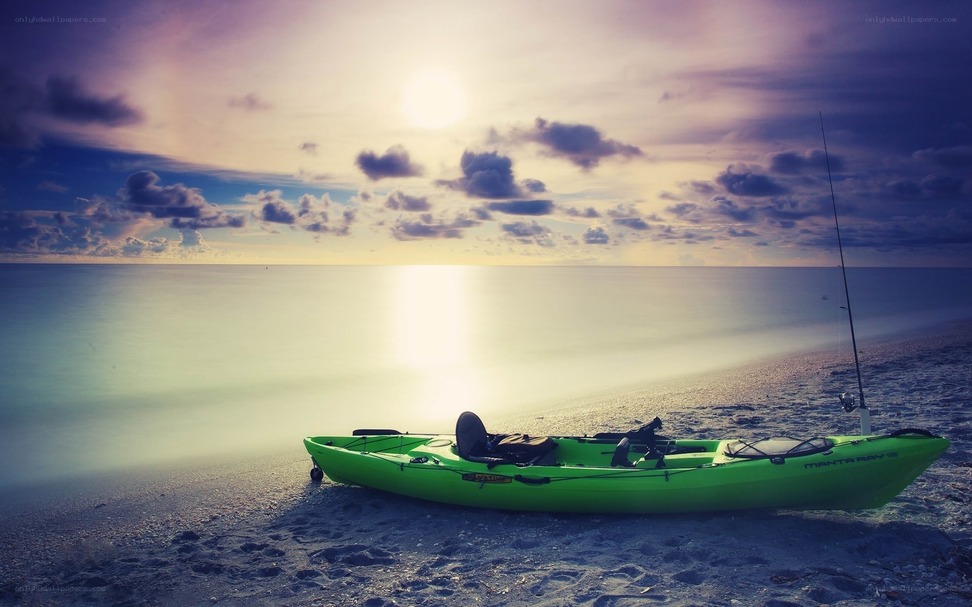 kayak on beach at sunset