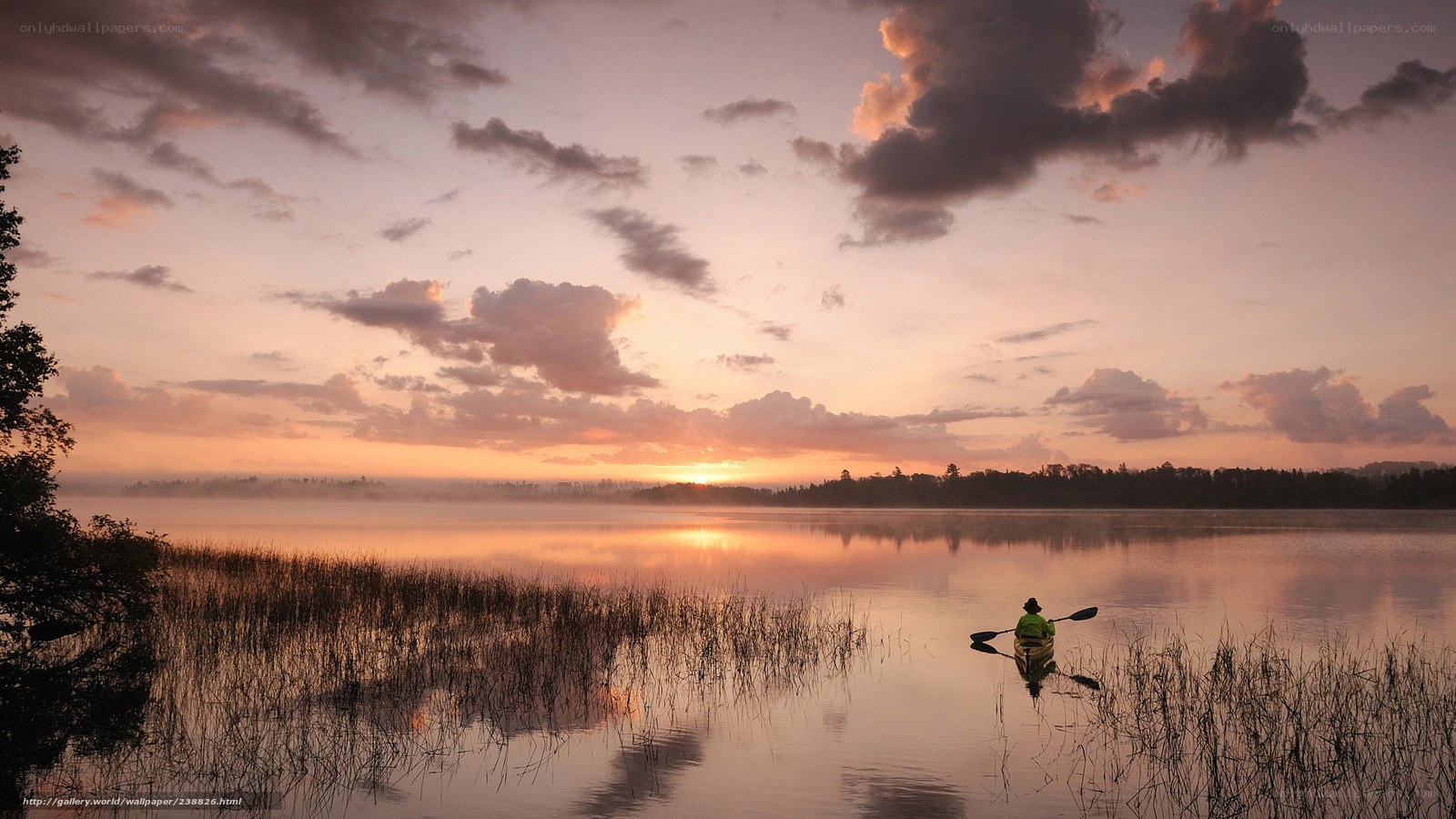 Kayaker at sunset on a calm lake