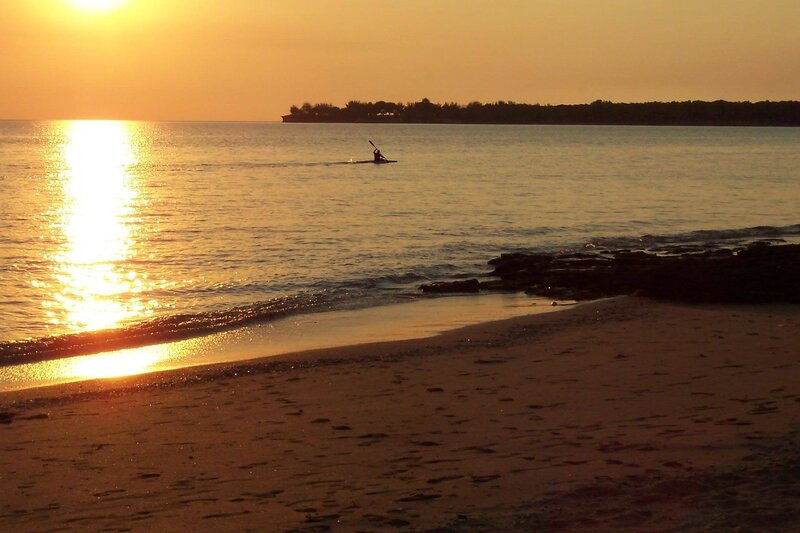 kayaker at sunset on beach