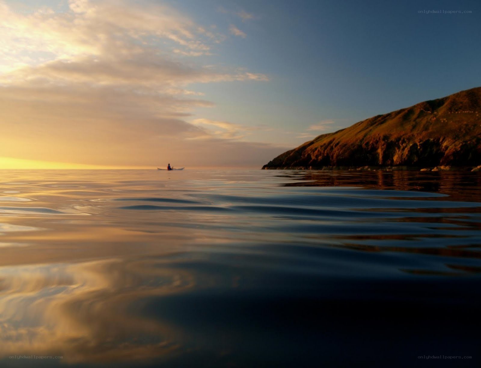 kayaker at sunset on calm sea