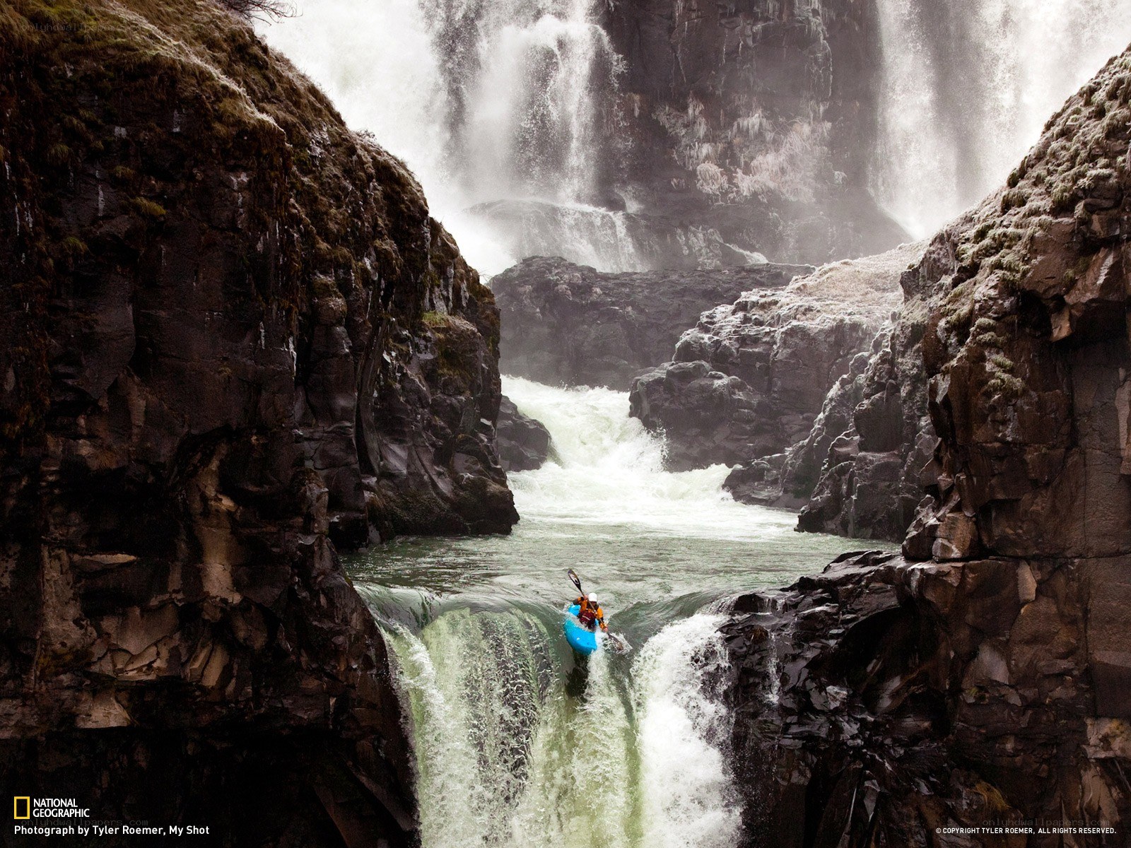 Kayaker descending waterfall