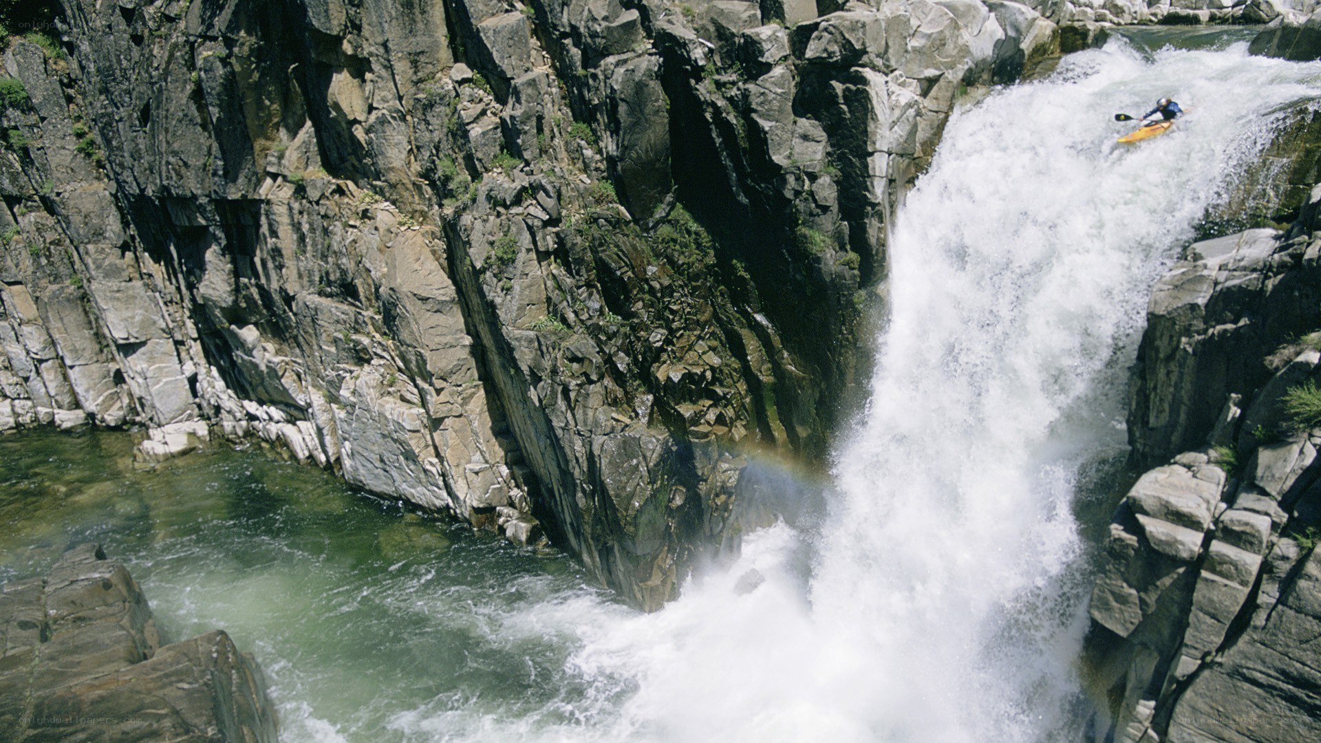 kayaker descending waterfall