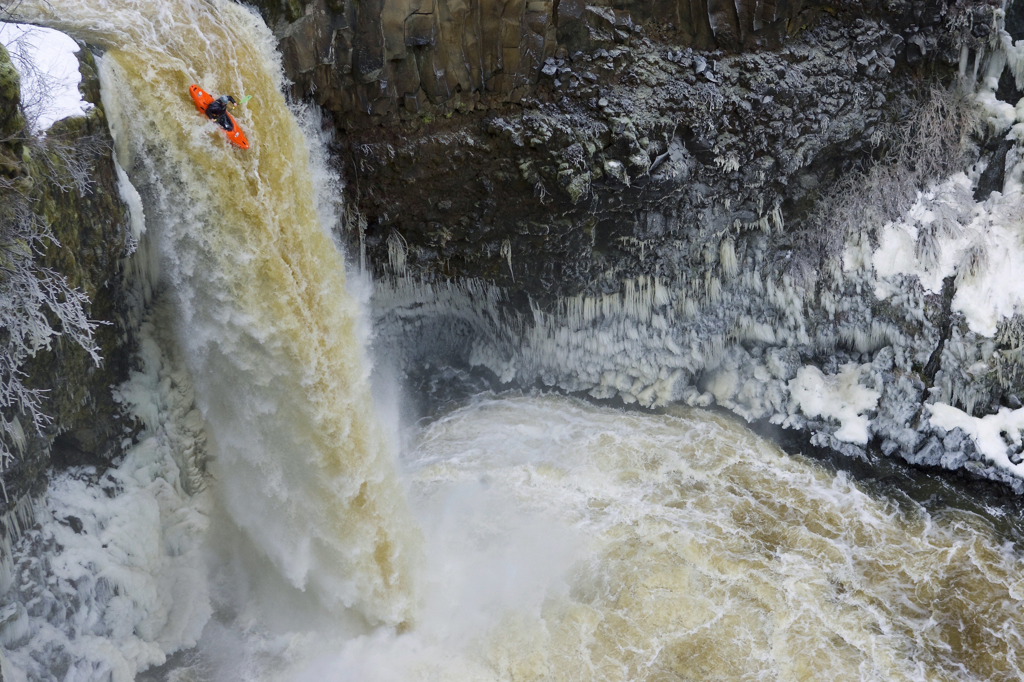 Kayaker descending waterfall