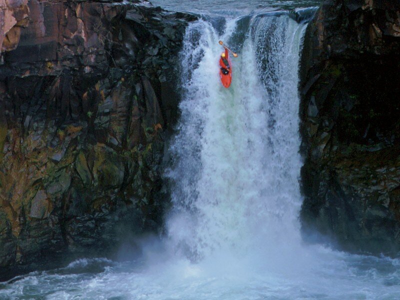 kayaker going over waterfall