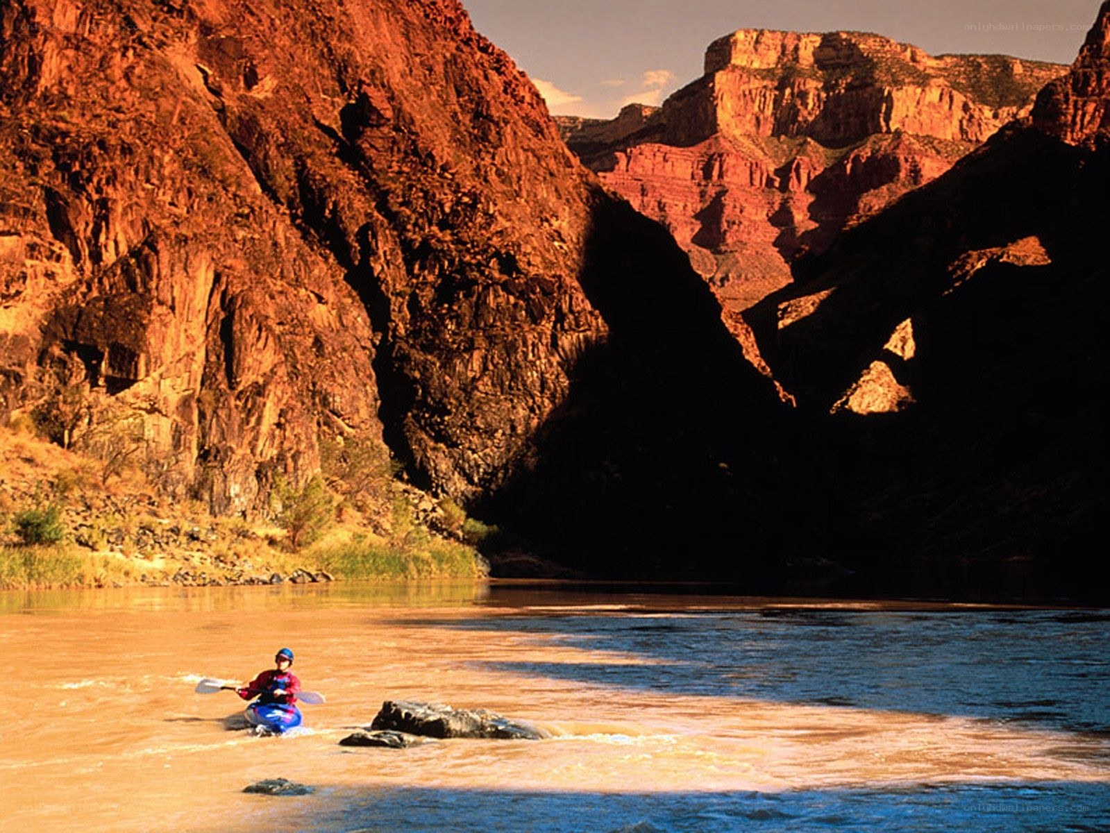 Kayaker in a canyon river