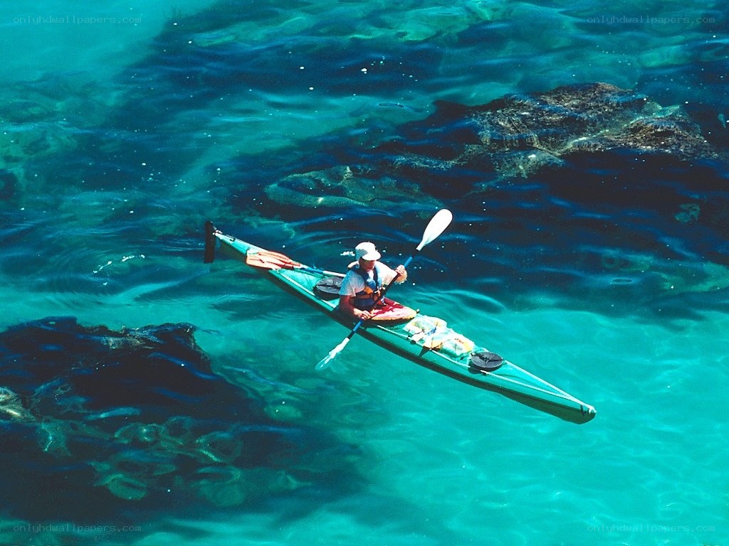 kayaker in clear turquoise water