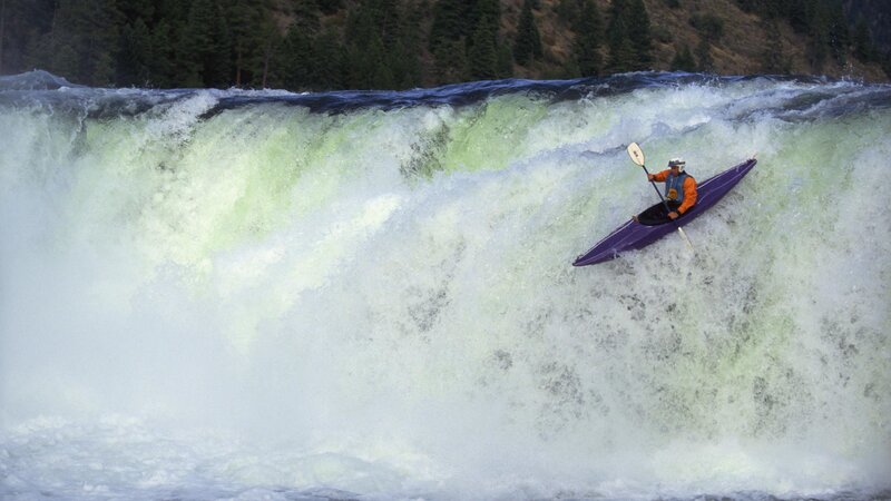 kayaker navigating a waterfall