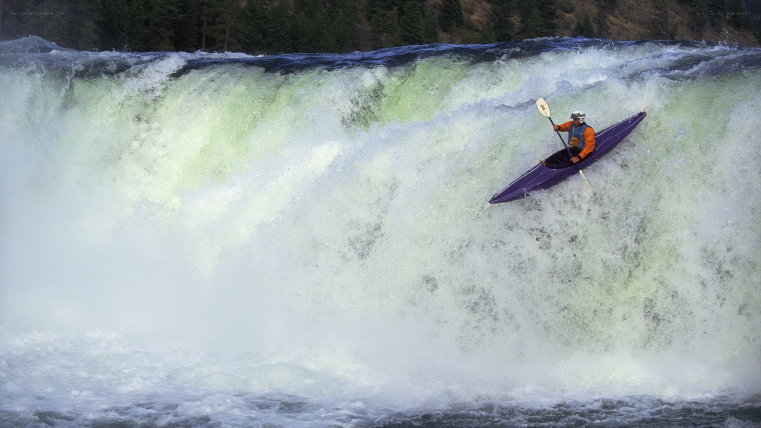 kayaker navigating a waterfall
