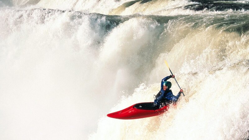 kayaker navigating whitewater rapids