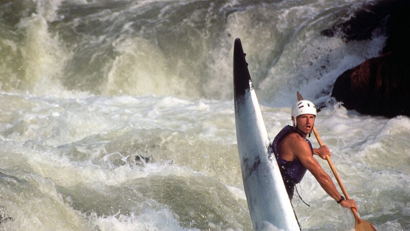 kayaker navigating whitewater rapids