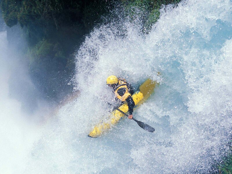 kayaker navigating whitewater rapids